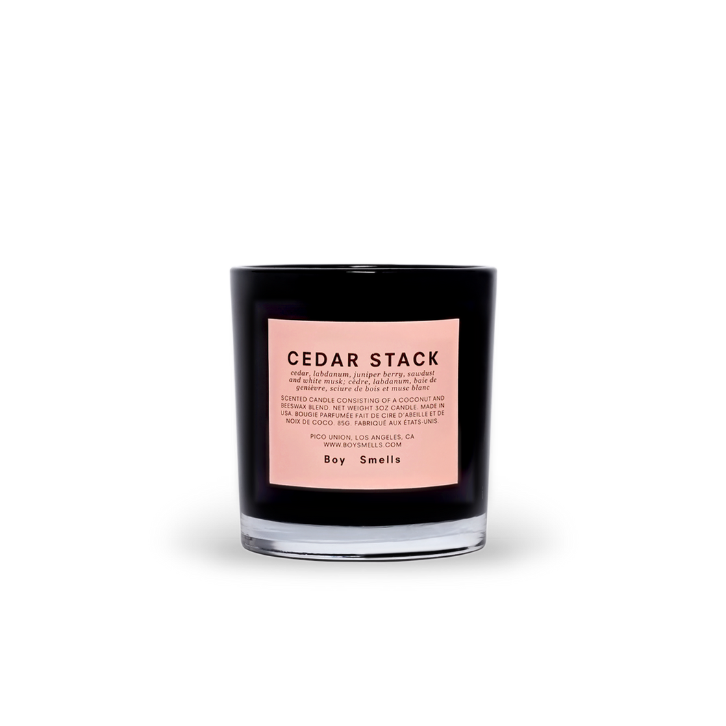 black candle jar with pink label